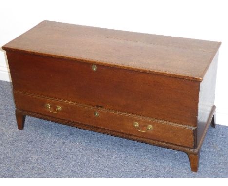 A George III oak chest; the hinged top with strap hinges and above a lower full-width drawer with ovolo mouldings, raised on 