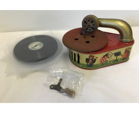 A vintage Pixie Phone tin plate Gama 54 toy gramophone, circa 1940's. Together with a small collection of records, spare need