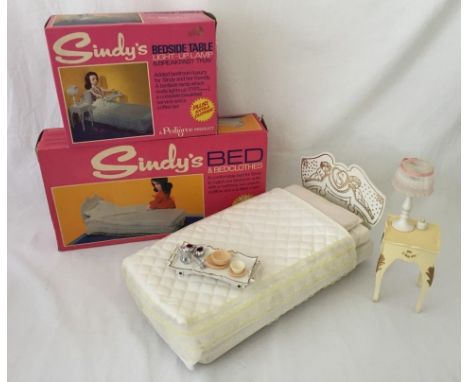 A boxed Sindy bed together with a boxed bedside table, light up lamp and breakfast tray. One leg to bed broken but in box. 