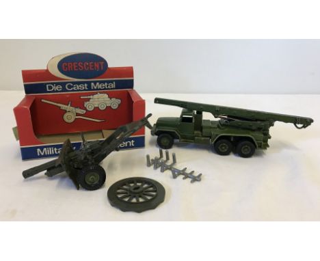 A boxed Crescent #1250 25 Pounder Light Artillery Gun with an unboxed Dinky military vehicle. Gun complete with wheel base an