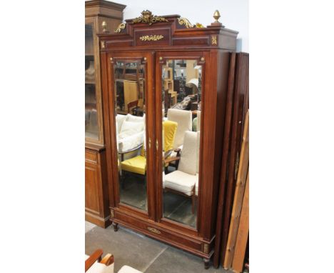 A continental gilt mounted walnut armoire with mirrored doors, width 126cm, depth 48cm & height 233cm.Condition:- General wea