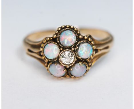 A precious opal and diamond ring, the cluster measuring approx. 11mm in diameter, band unmarked, gross wt. 2.28g, size O.  Co