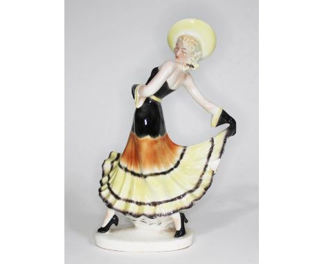 A Goldscheider style Art Deco figure of a woman in stylised pose, the base stamped 35293, height 28.5cm.  There is a repair t