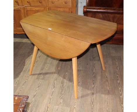 A vintage Ercol light elm and beech drop leaf dining table, height 72cm, width 113cm and depth 63cm opening to 113cm.  Good c