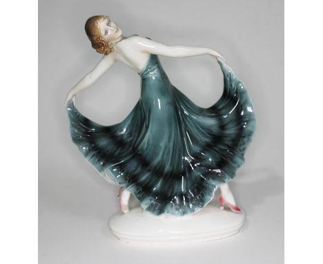 A German Art Deco Goldscheider style figure of a woman in stylised pose, the base inscribed '12355', height 27cm.  There are 