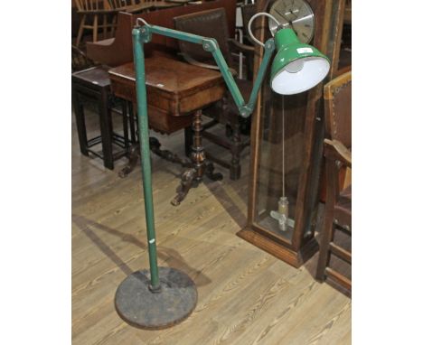An industrial green painted angle lamp on weighted base.  