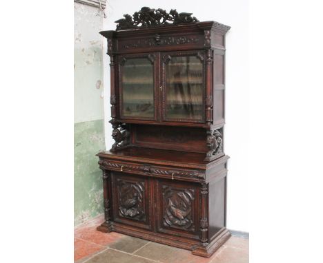 A Victorian carved cabinet bookcase, width 138cm, depth 56cm & height 244cm.Condition:- General wear through age and use, som
