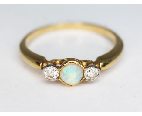 A precious opal and diamond ring, marks rubbed, gross wt. 2.55g, size P.&nbsp;Condition - band a little rubbed, central caboc