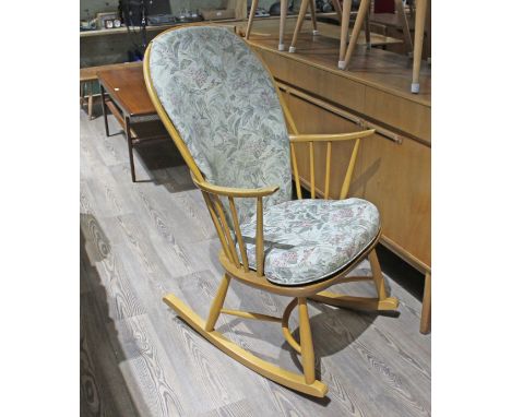 An Ercol light elm and beech 'Swan Back' rocking chair with crinoline stretcher.  Good solid condition, no loose joints or wo