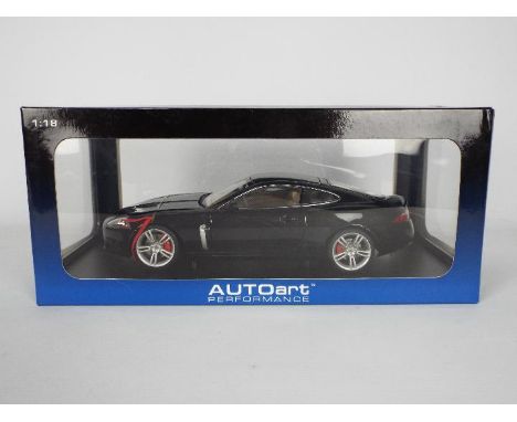 AutoArt - A boxed AutoArt 1:18th scale #73634 Jaguar XKR Coupe. The model in Midnight Blue appears to be in Mint condition in