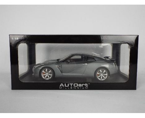 AutoArt - A boxed 1:18 scale Nissan GT-R in Dark Metallic Grey # 77388. This car appears appears Mint but has been on display