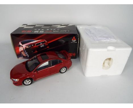 Mitsubishi - A boxed 1:18 scale diecast model of a Mitsubishi Lancer EX. The model in red appears to be in Near Mint conditio
