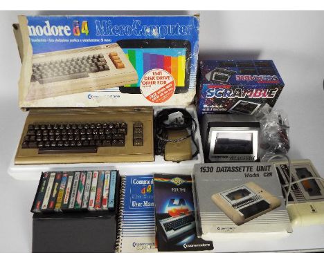Commodore - Grandstand - A boxed vintage Commodore 64 computer with a boxed 1530 Datasette unit, a case of 12 x games cassett