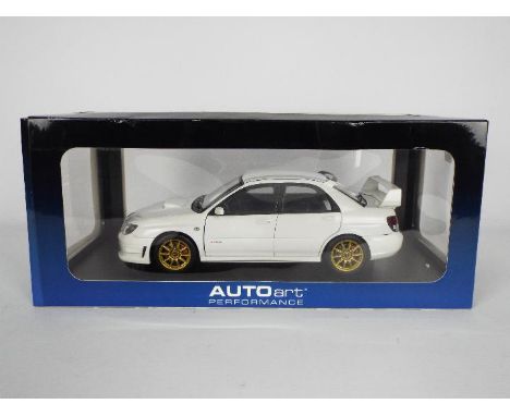 AutoArt - A boxed 1:18 scale Subaru Impreza WRX STi 2006 in Plain White # 78682. The car appears Mint but has been out on dis
