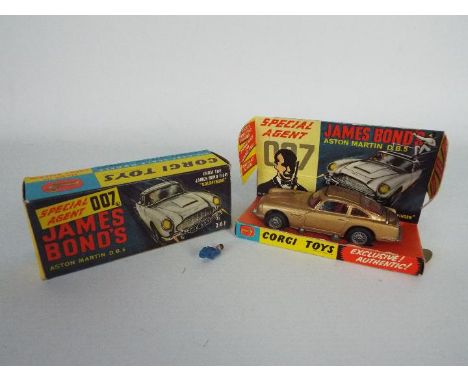 Corgi - A boxed # 261 James Bond Aston Martin DB5 with 2 x baddie figures. The car appears in Good condition with signs of pl