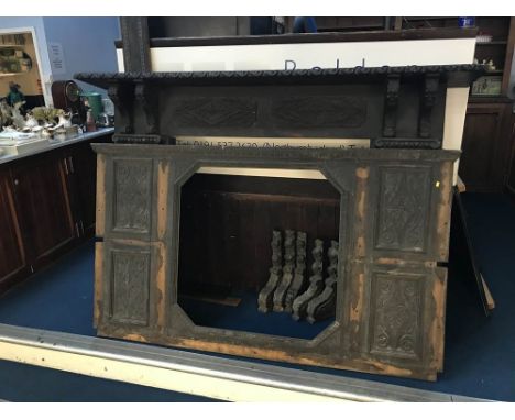 A large carved oak fire surround
