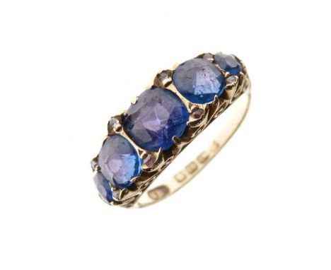 Late Victorian 18ct gold and five stone ring, set five graduated blue stones within scroll shoulders, Birmingham 1899, size N