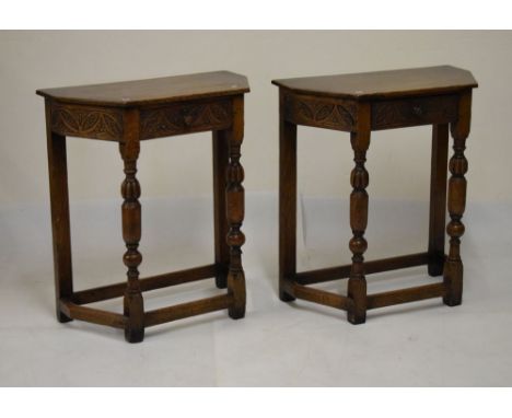 Pair of old reproduction oak 'credence'-style occasional tables, each with canted oblong top over carved single drawer and fr