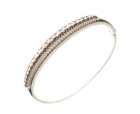 Diamond set hinged bangle, in 18ct white gold, the graduated stones totalling approximately 0.8 carats, internal diameter 5.6