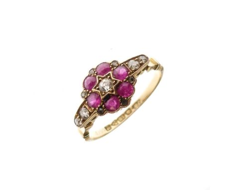 George V 18ct gold, ruby and diamond cluster ring of flowerhead design with central diamond, six rubies and diamonds to shoul