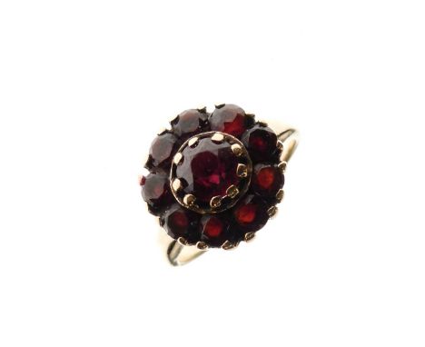 Yellow metal cluster ring of flowerhead design set ten red garnet-coloured stones, shank marked 9ct, size L, 4.2g gross appro