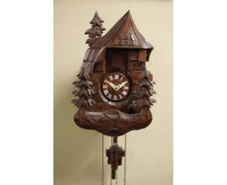 Mid 20th Century carved wooden cuckoo clock with Christmas tree decoration and pine cone weights, 26cm high excluding pendulu