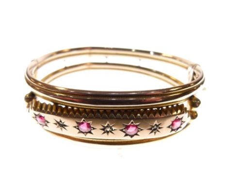 Edwardian 9ct rose gold snap bangle set a central band of red stones and diamond points, 12.5g approx  