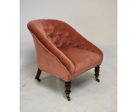 Victorian tub chair having pink button back upholstery, raised on turned walnut supports, fitted brass casters  