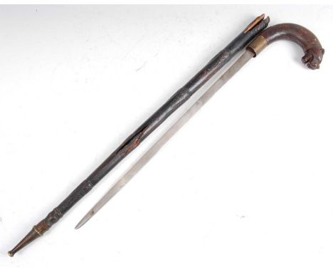 A 19th century ebonised sword stick, having a 49cm blade, the handle carved as a tigers head, 80cm.