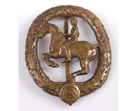 A collection of military badges and buttons to include a German Horseman's badge (Das Duetsches Reitterabzeichen), the centra
