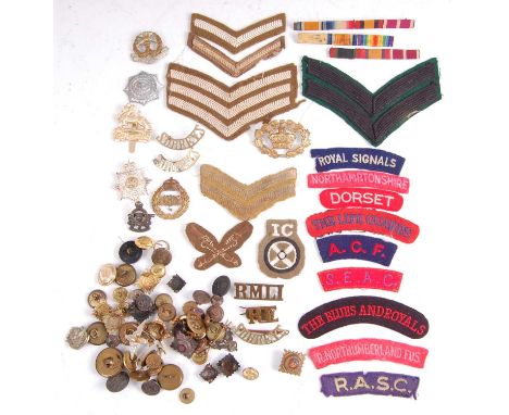 A collection of cap badges, buttons and cloth shoulder titles to include The Life Guards, R. Northumberland Fusiliers, The Bu
