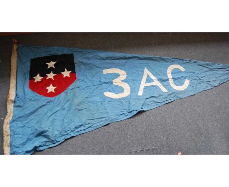 A large cotton flag of triangular form, on a blue ground with stitched black and red shield with five stars and 3 AC, 110 x 2