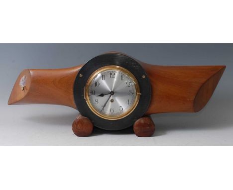 An early 20th century propeller mantel clock, the silvered dial with Arabic numerals set within the boss of an unmarked prope