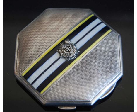 A ladies silver and enamelled powder compact, having engine turned decoration and bearing a crest for the Royal Army Service 