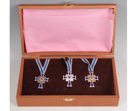 A collection of three Cross of Honour of the German Mother medals in bronze, silver and gold, boxed.Condition report: In our 