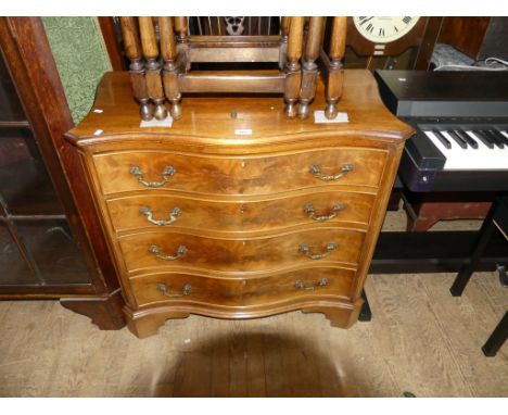 A good quality reproduction serpentine fronted chest of drawers, raised on bracket supports
