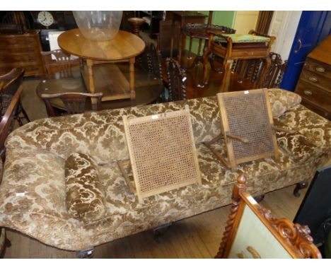 A 19th Century large four seater sofa upholstered in a floral material, raised on four ball and claw feet.