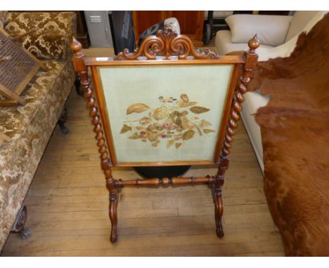 A 19th Century mahogany framed fire screen with tapestry panel depicting a bird and foliage, with spindle sides.