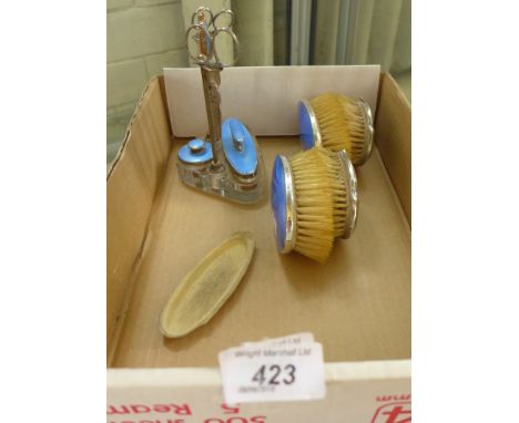 A silver and blue enamel mounted part dressing table set, comprising brushes, manicure items, nail buffer, etc.