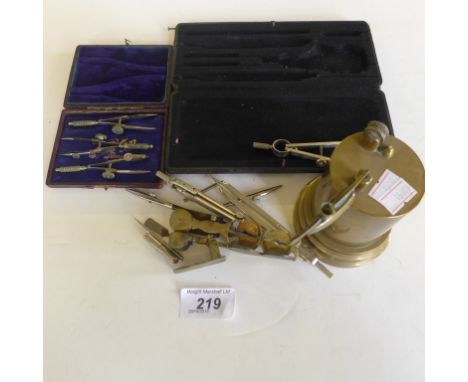 A mixed lot comprising sovereign scales, brass trench art lighter, and two cases of drawing instruments.