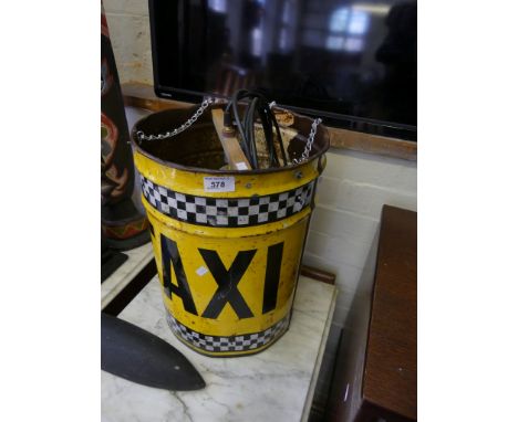 A decorative up-cycled circular yellow metal tin entitled 'Taxi' converted to a ceiling light.