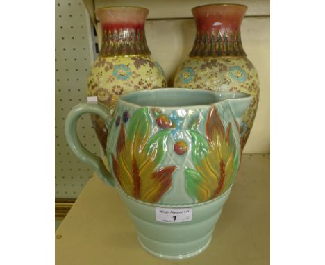 A Clarice Cliff Newport pottery jug with looped handle marked 41A to base, together with a pair of Doulton Lambeth baluster v