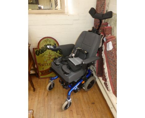 An Invacare REM 24SD motorised wheelchair, complete with key, instruction manual, power pack etc.