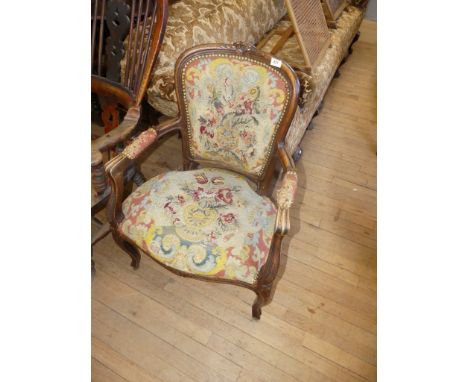 A 19th Century style French armchair upholstered with a floral tapestry material.