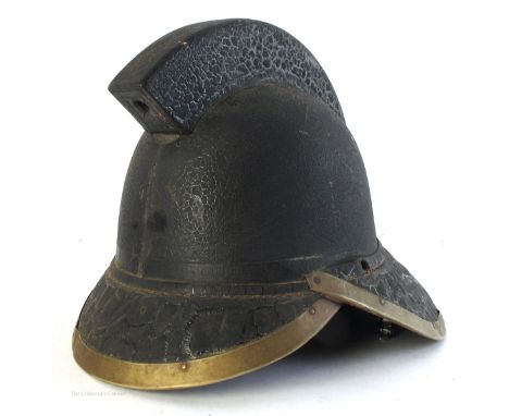 Early 20th century. Fireman's helmet by James Hendry Glasgow, of substantial leather and brass construction, 10" (26cm) high.