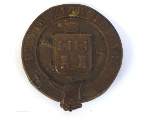 Dublin Fire Brigade helmet plate. A die-stamped brass helmet plate centred with the arms of the City of Dublin and emblazoned