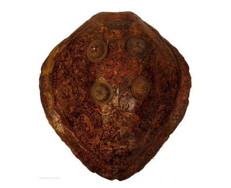 A 19th century Rajasthani turtle-shell dhal or shield, hand painted in gold with hunting scenes enclosed in a floral border, 