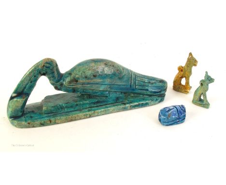 A small collection of Egyptian faience. Two small ceramic amulets of Bastet, the cat godess, a scarab bead, and a faience fig