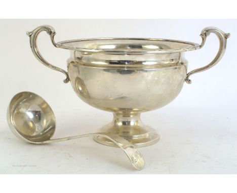 A George V silver punch bowl with ladle en suite, the two-handled  bowl with reeded rim, Sheffield, 1917, maker's mark for Co