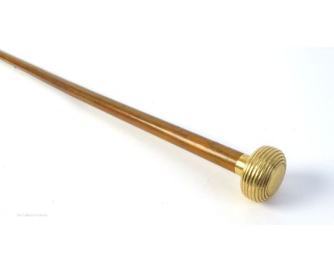 A 20th century gold mounted, French cane or swagger stick. The reeded bun-shaped knob with French 18ct  assay mark, on tapere